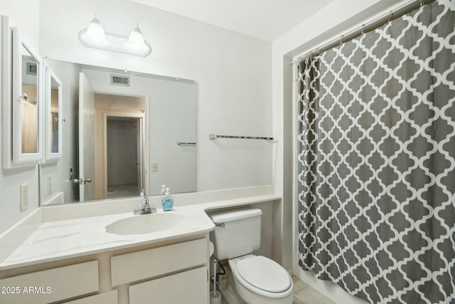 bathroom with tile patterned flooring, vanity, and toilet