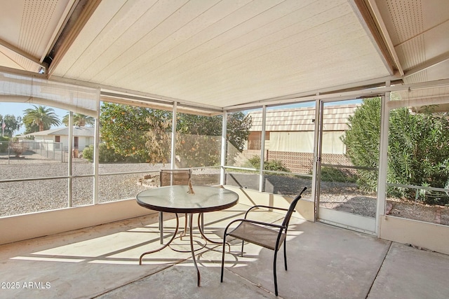 unfurnished sunroom with a healthy amount of sunlight and vaulted ceiling