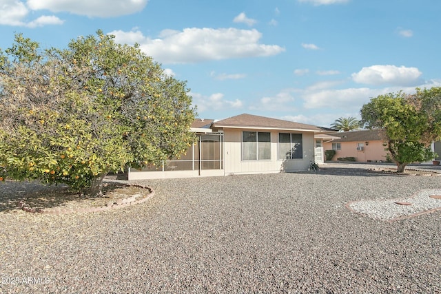 back of house featuring a sunroom