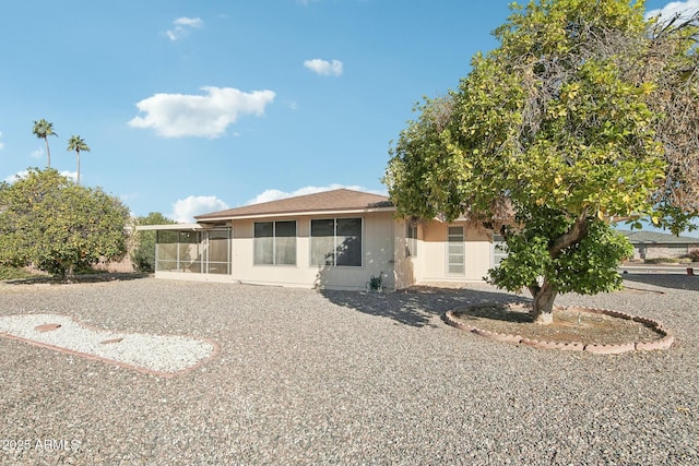 rear view of property with a sunroom