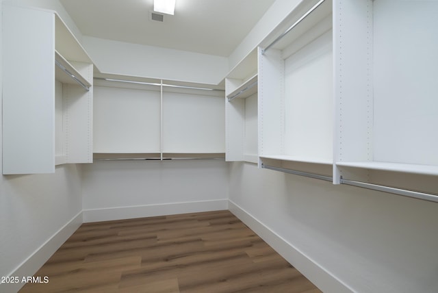 spacious closet with visible vents and wood finished floors