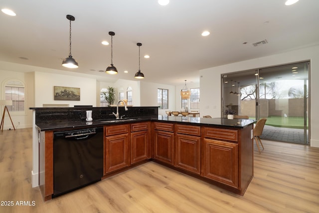 kitchen featuring visible vents, recessed lighting, a sink, black dishwasher, and light wood-style floors