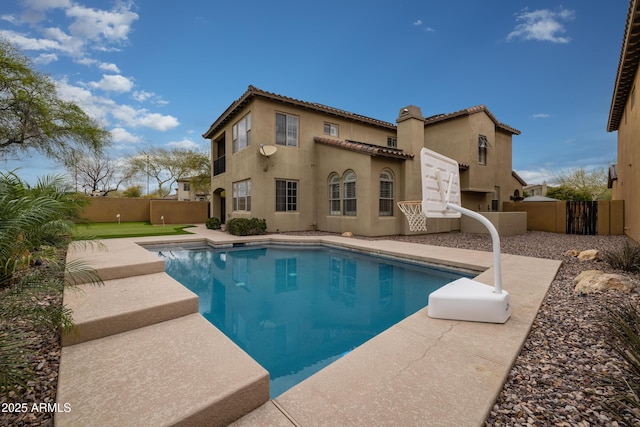 view of swimming pool featuring a fenced in pool, a patio, and a fenced backyard