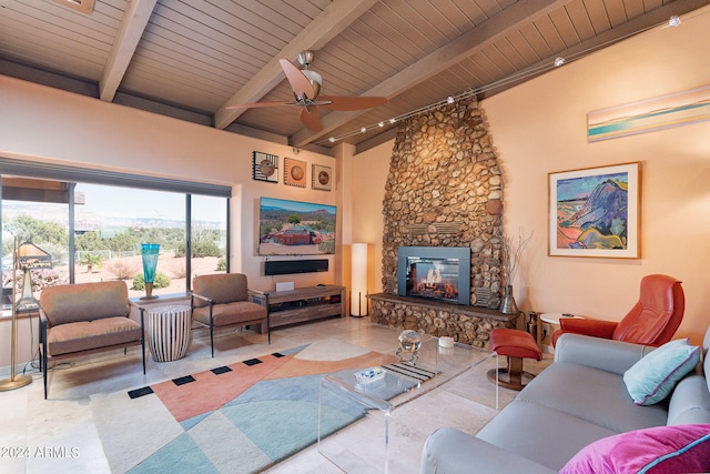 living room with ceiling fan, beamed ceiling, a fireplace, and wood ceiling