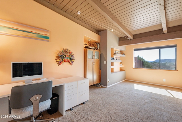 unfurnished office featuring light carpet, beamed ceiling, built in desk, and wooden ceiling