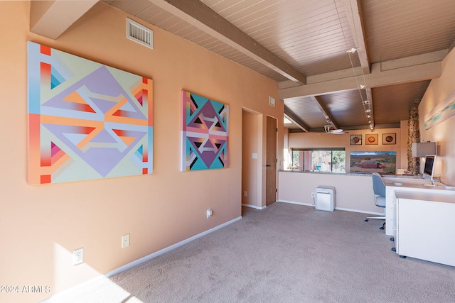 unfurnished office with beam ceiling and light colored carpet