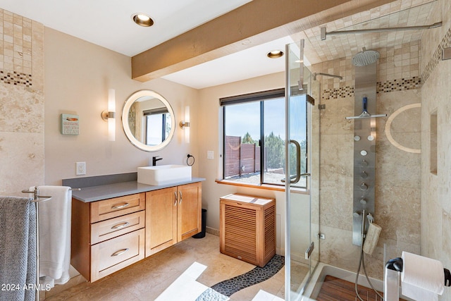 bathroom with tile patterned flooring, vanity, and an enclosed shower