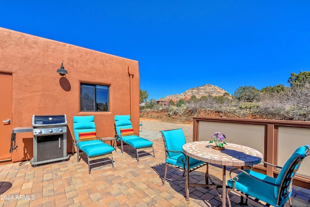 view of patio with a mountain view and a grill