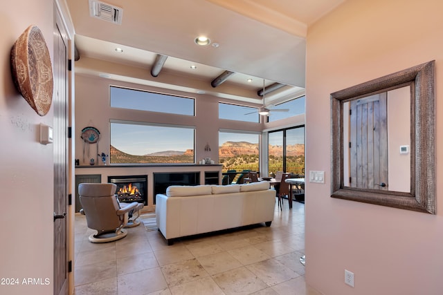 living room with ceiling fan and beam ceiling