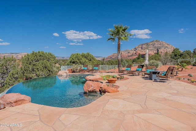 view of pool with a patio and a mountain view