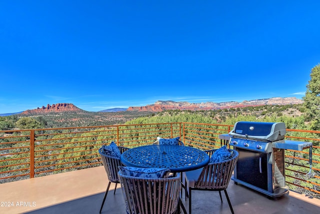 view of patio / terrace featuring grilling area and a mountain view