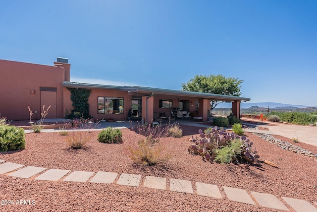 exterior space with a mountain view and a patio