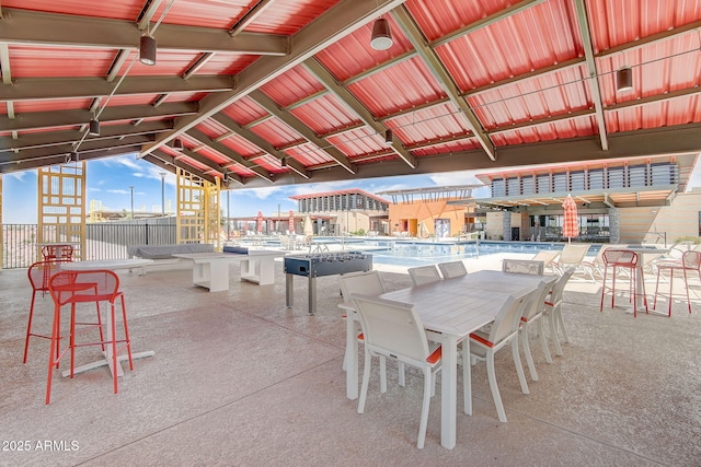 view of patio with outdoor dining space and a community pool