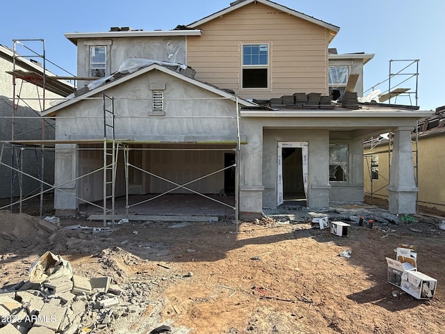 back of property with a garage