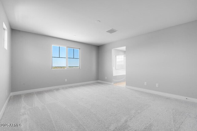 12219 W Caraveo Pl, Peoria, AZ 85383 - spare room featuring carpet floors and baseboards