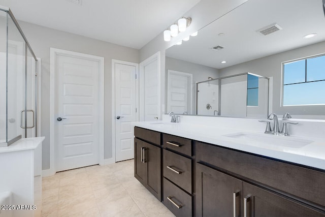 12219 W Caraveo Pl, Peoria, AZ 85383 - full bathroom with a shower stall, double vanity, recessed lighting, and baseboards