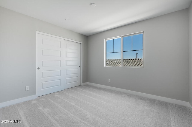 12219 W Caraveo Pl, Peoria, AZ 85383 - unfurnished bedroom with baseboards, carpet flooring, and a closet