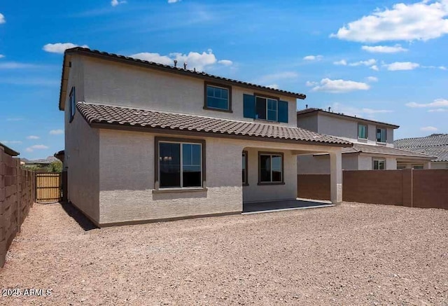 12219 W Caraveo Pl, Peoria, AZ 85383 - back of property featuring a tiled roof, stucco siding, a fenced backyard, and a patio