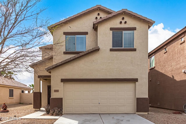 view of front of property featuring a garage, a tile roof, and stucco siding