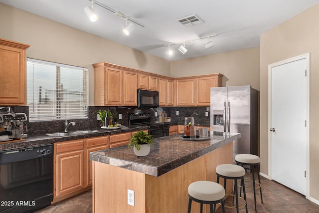 kitchen with tile countertops, visible vents, backsplash, a sink, and black appliances