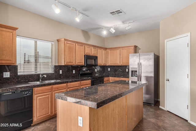 kitchen with a sink, visible vents, backsplash, tile counters, and black appliances