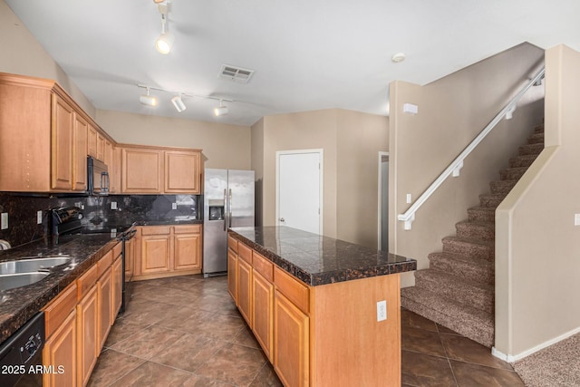 kitchen featuring a kitchen island, visible vents, backsplash, tile counters, and black appliances