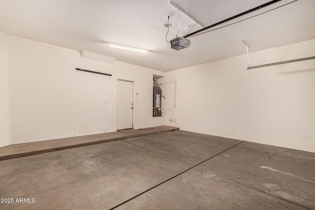 garage featuring baseboards, gas water heater, and a garage door opener