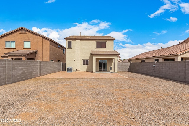 back of property featuring central air condition unit, stucco siding, a fenced backyard, and a patio