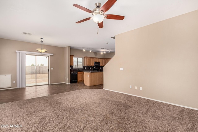 unfurnished living room featuring dark colored carpet, dark tile patterned flooring, visible vents, and baseboards