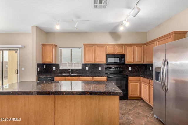 kitchen featuring visible vents, black appliances, backsplash, and tile counters