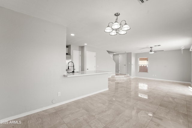 11215 W Heatherbrae Dr, Phoenix, AZ 85037 - unfurnished living room with ceiling fan, a chandelier, baseboards, recessed lighting, and light marble finish floors