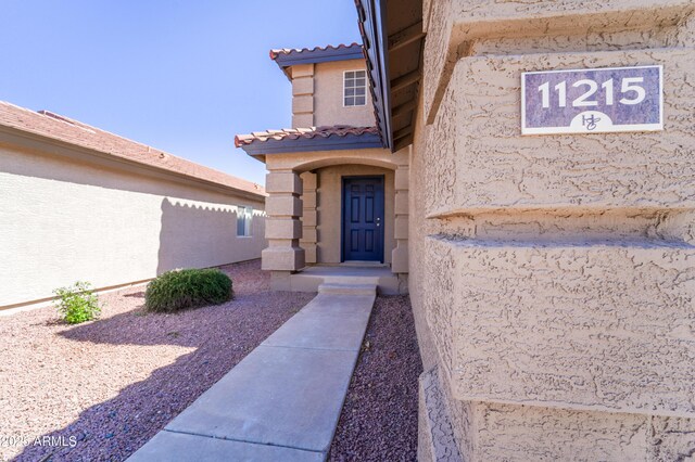 11215 W Heatherbrae Dr, Phoenix, AZ 85037 - property entrance with a tile roof and stucco siding