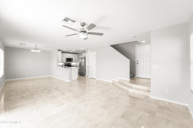 11215 W Heatherbrae Dr, Phoenix, AZ 85037 - unfurnished living room featuring ceiling fan, a chandelier, baseboards, recessed lighting, and a sink