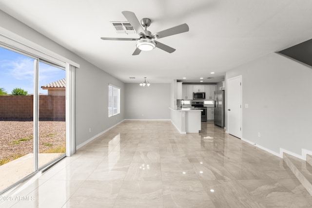 11215 W Heatherbrae Dr, Phoenix, AZ 85037 - unfurnished living room with a ceiling fan, baseboards, a chandelier, a sink, and recessed lighting