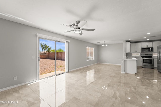 11215 W Heatherbrae Dr, Phoenix, AZ 85037 - unfurnished living room with a ceiling fan, a sink, a chandelier, baseboards, and recessed lighting