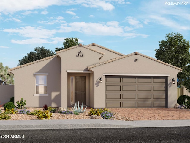 mediterranean / spanish house with a tiled roof, decorative driveway, an attached garage, and stucco siding