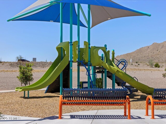 community jungle gym with a mountain view