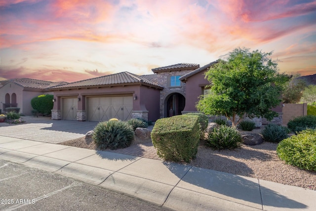 mediterranean / spanish-style home with a garage