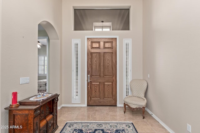 tiled foyer entrance featuring a high ceiling