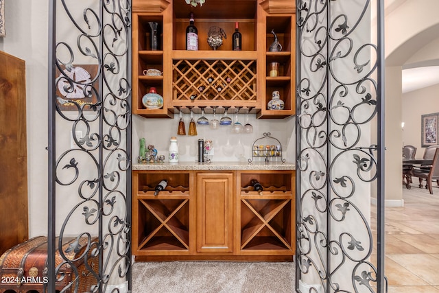 wine room with light colored carpet and indoor bar