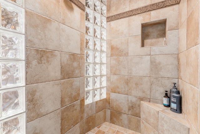 interior details featuring tiled shower