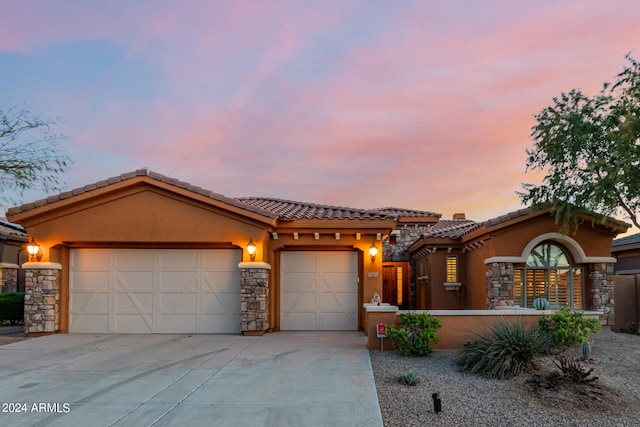 mediterranean / spanish-style house with a garage