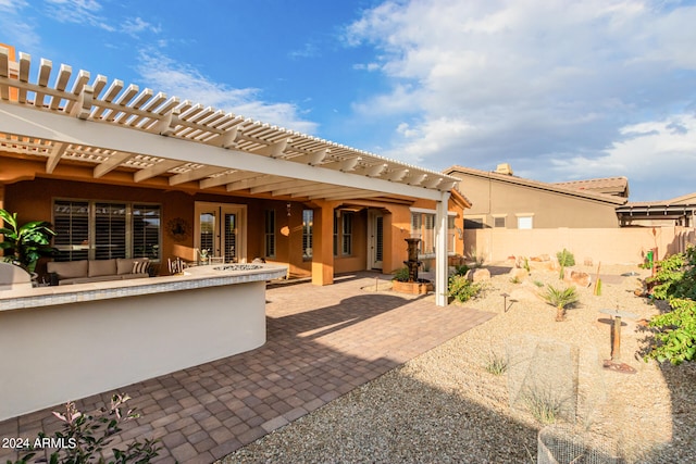 rear view of house with a pergola and a patio