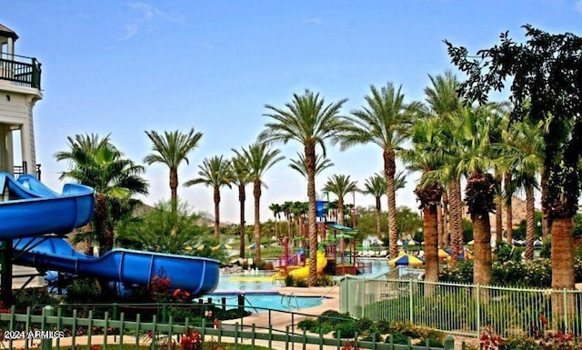 view of jungle gym featuring a community pool