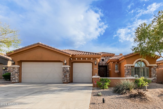 mediterranean / spanish home featuring a garage