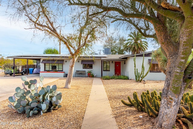 view of front of property featuring a carport