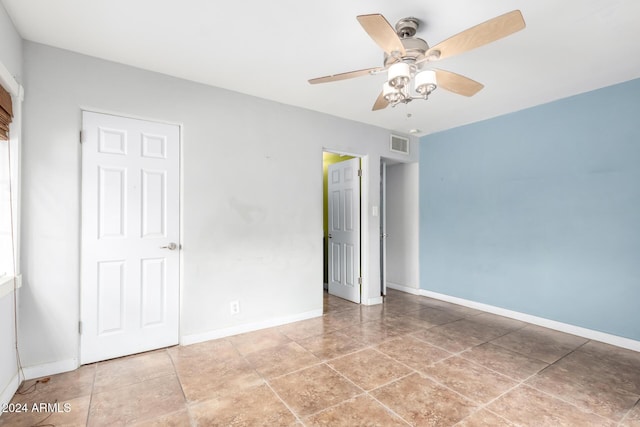 unfurnished bedroom featuring tile patterned floors and ceiling fan