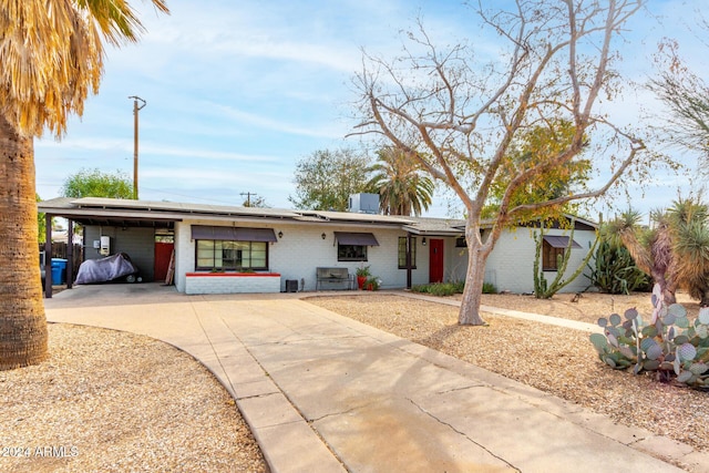 single story home featuring a carport