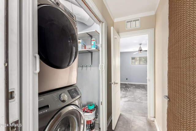 clothes washing area with stacked washer and dryer, ceiling fan, and ornamental molding