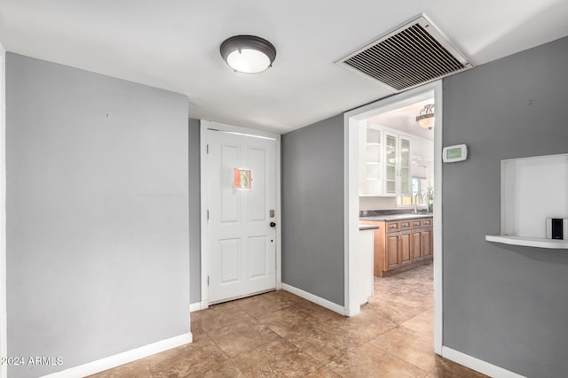 tiled entryway with sink